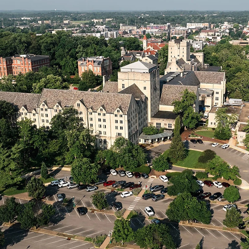 a large building with trees and a parking lot