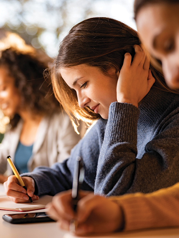 a woman writing on a piece of paper