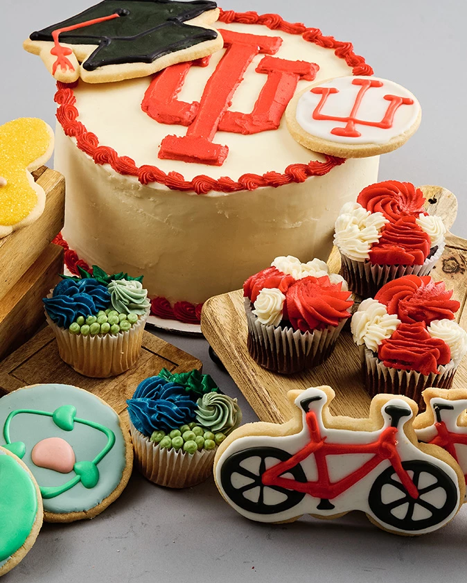 a cake and cupcakes with frosting