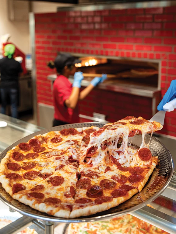 a pizza being prepared for a pizza oven