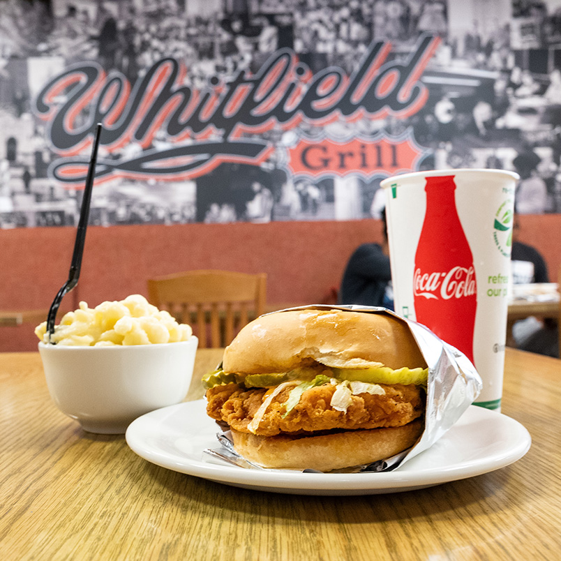 a burger and macaroni and cheese on a plate