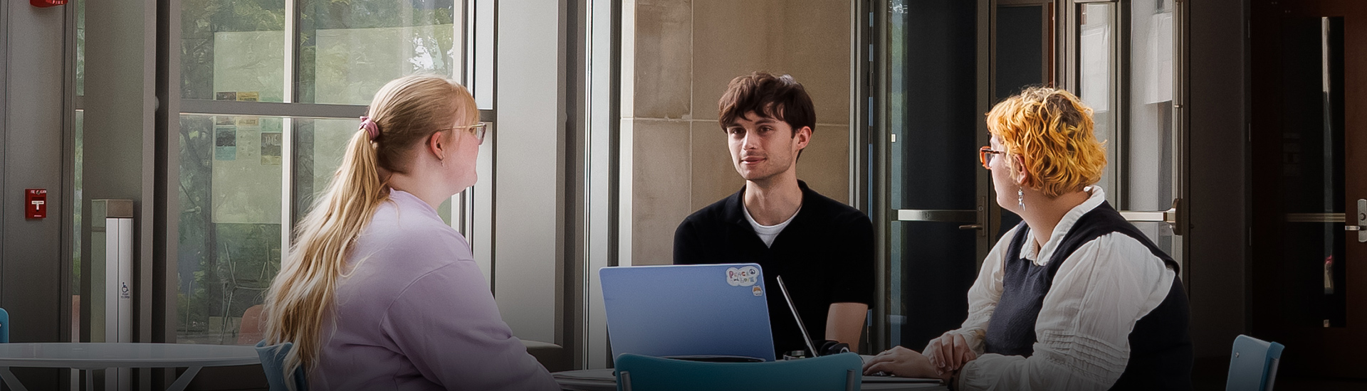 a man sitting at a desk with a laptop