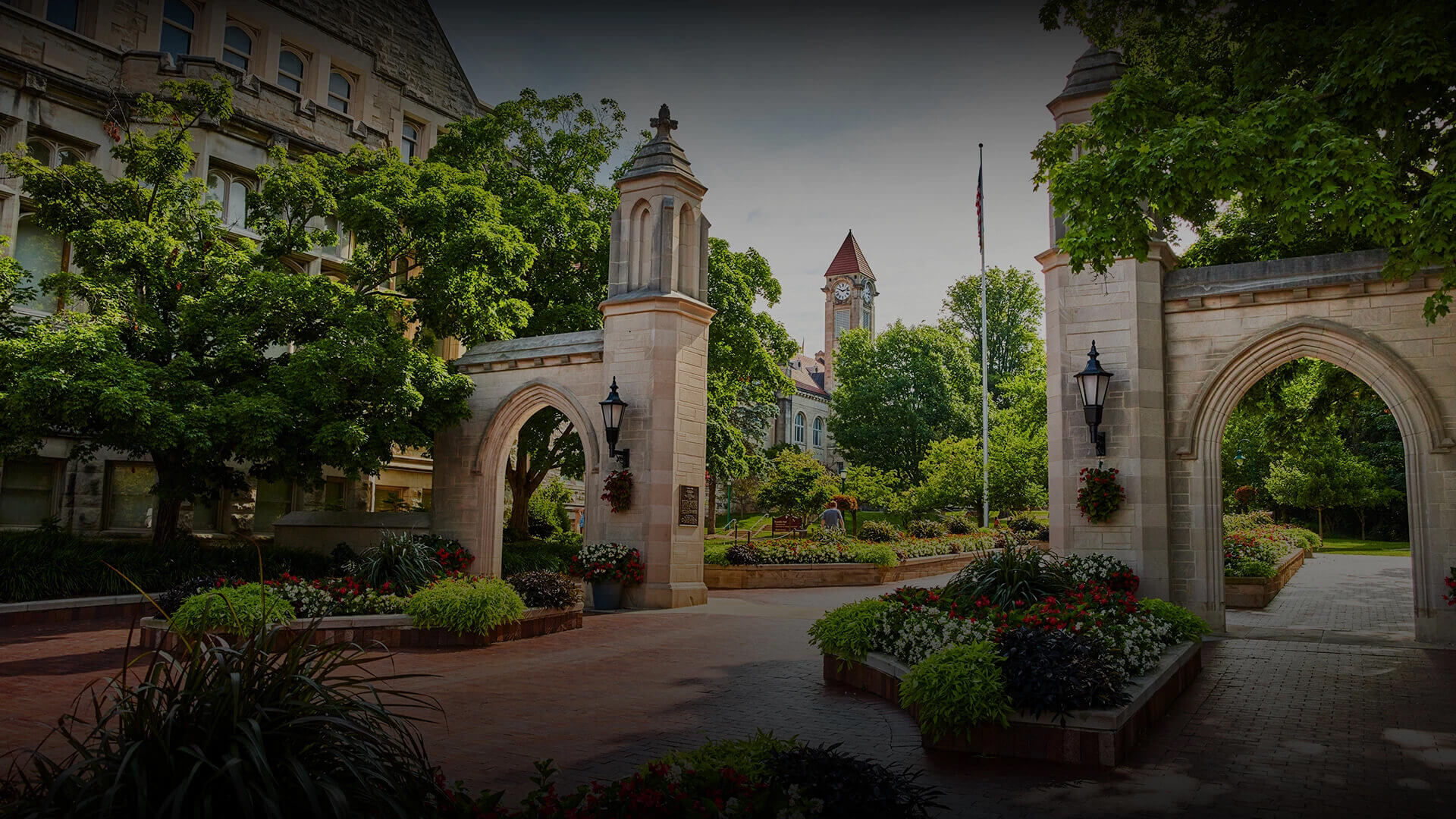 a stone archway with a clock tower in the background