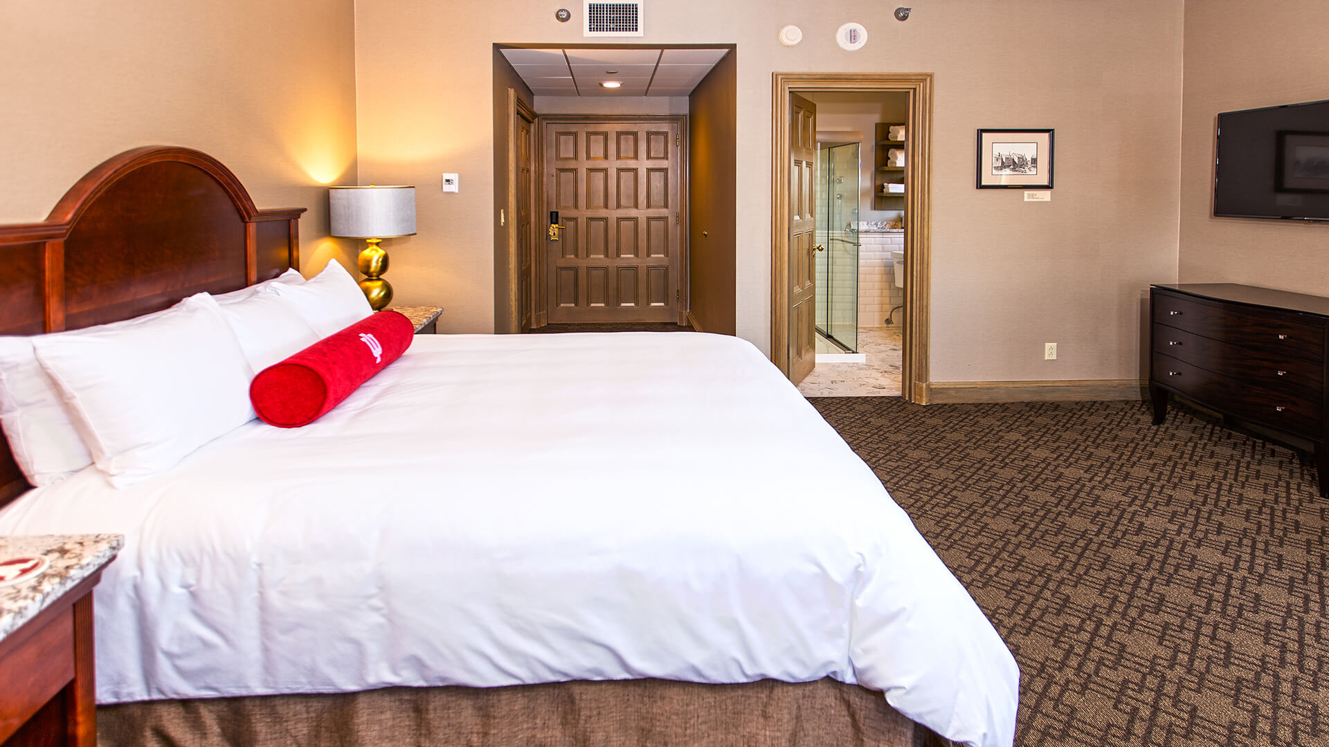 a hotel room with a bed and a door