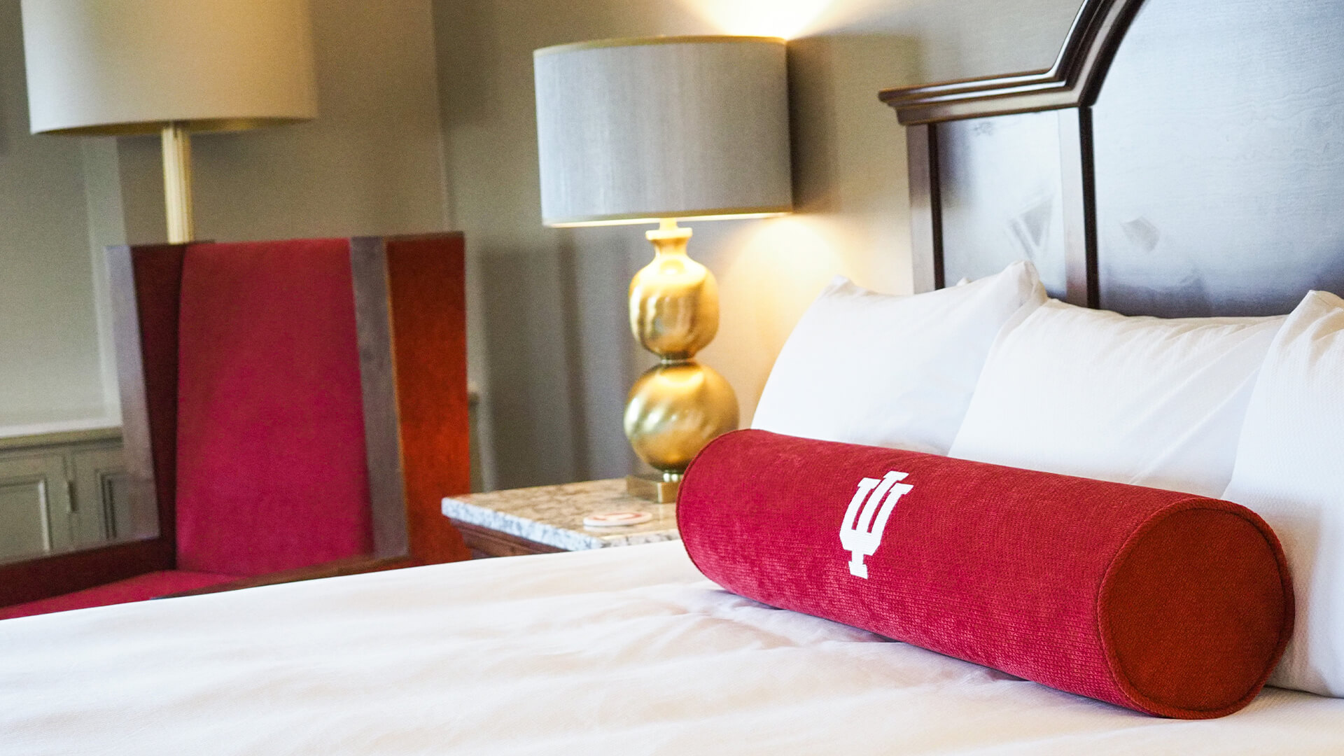 a red pillow on a bed