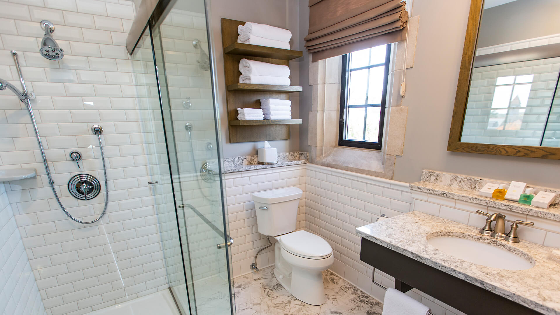 a bathroom with a glass shower and toilet