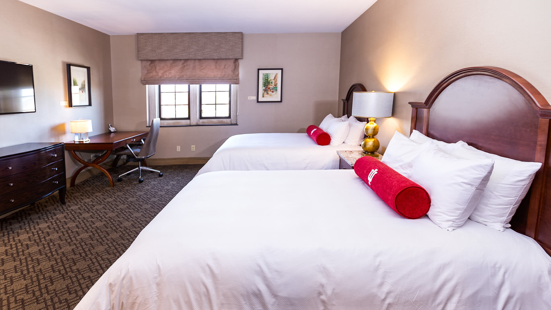 a room with two beds and a desk