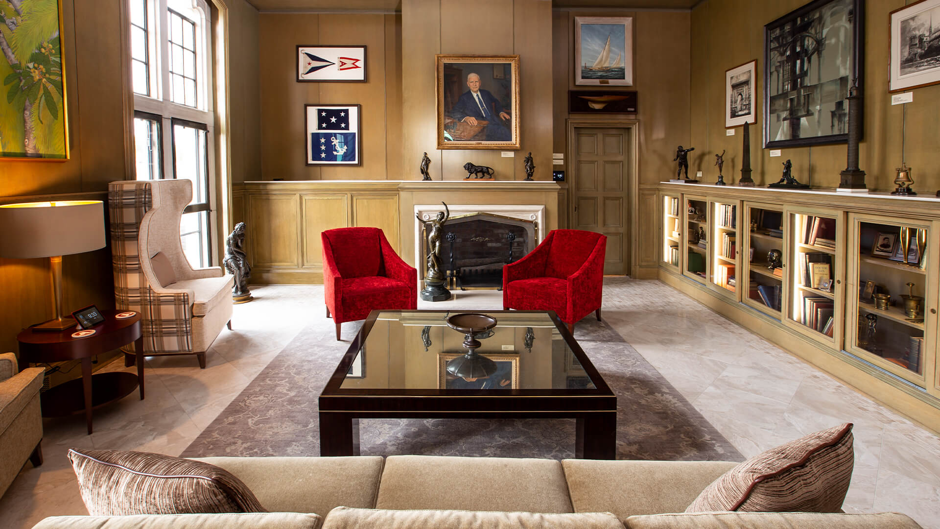 a room with a fireplace and red chairs