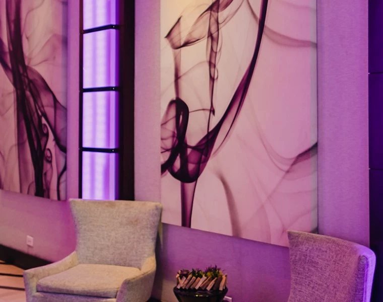 a room with chairs and art on the wall