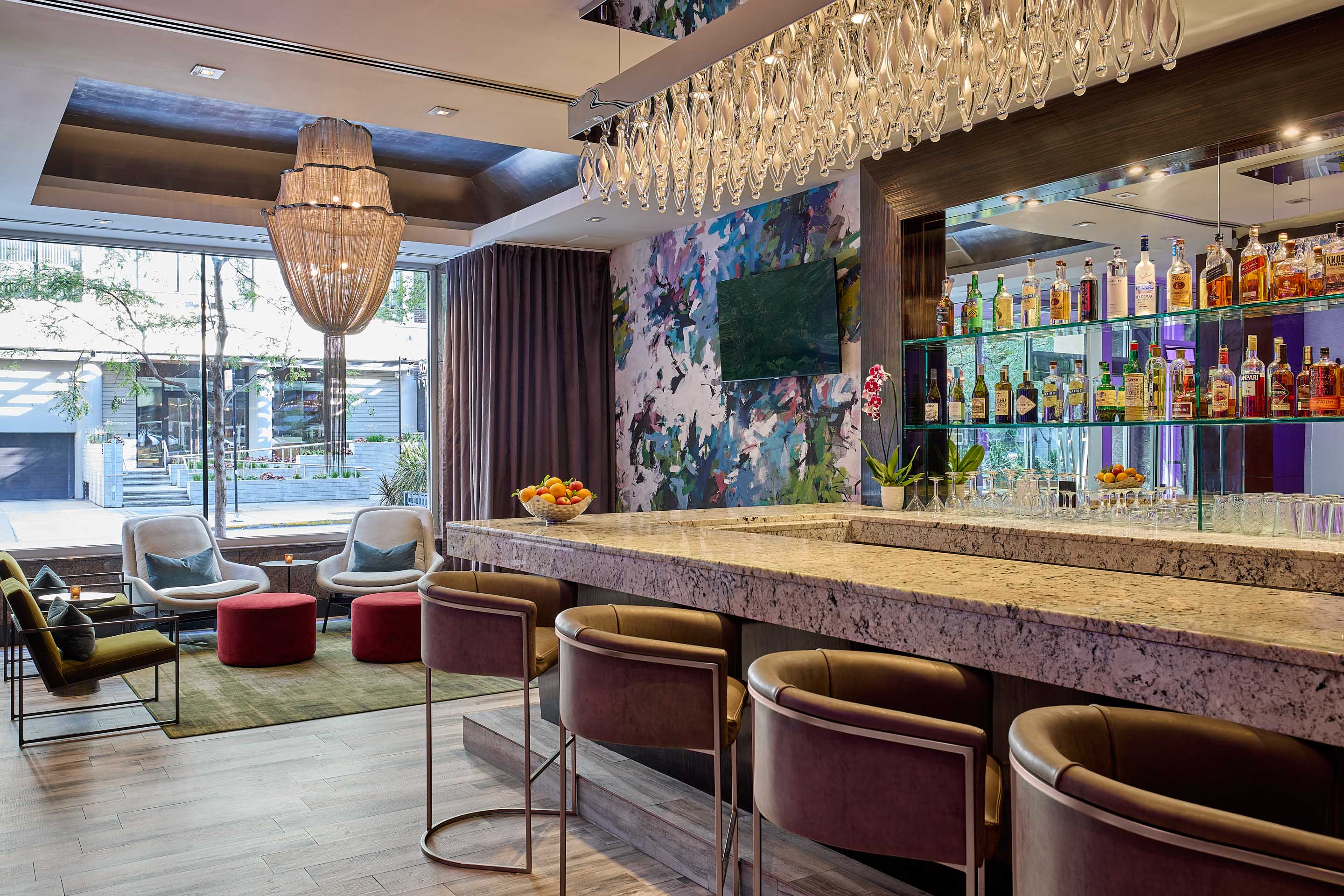 a bar with chairs and a chandelier