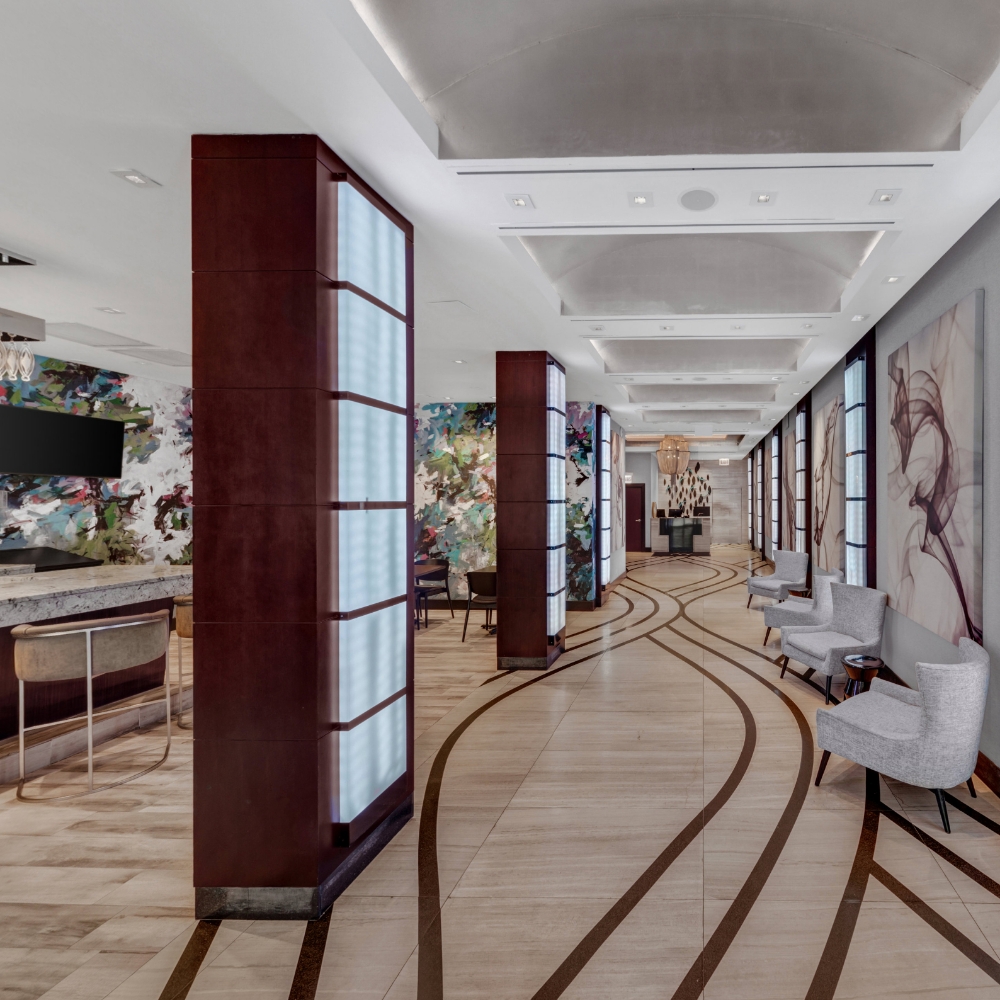 a lobby with chairs and art on the wall