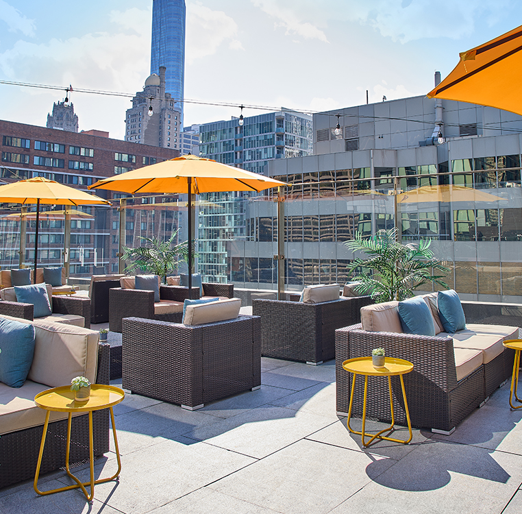a patio with chairs and umbrellas