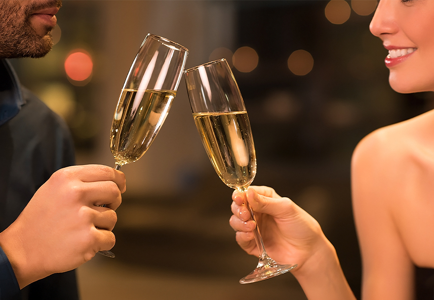 a couple of people clinking champagne glasses