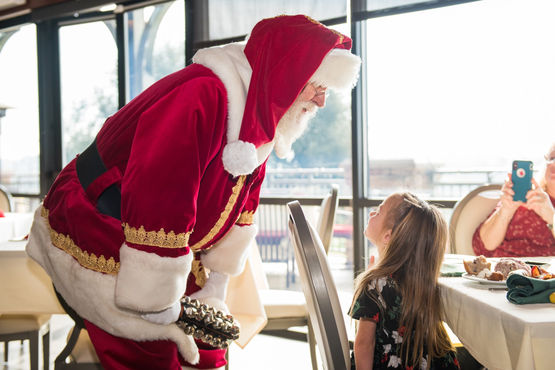 a man in a red and white garment with a girl looking at him