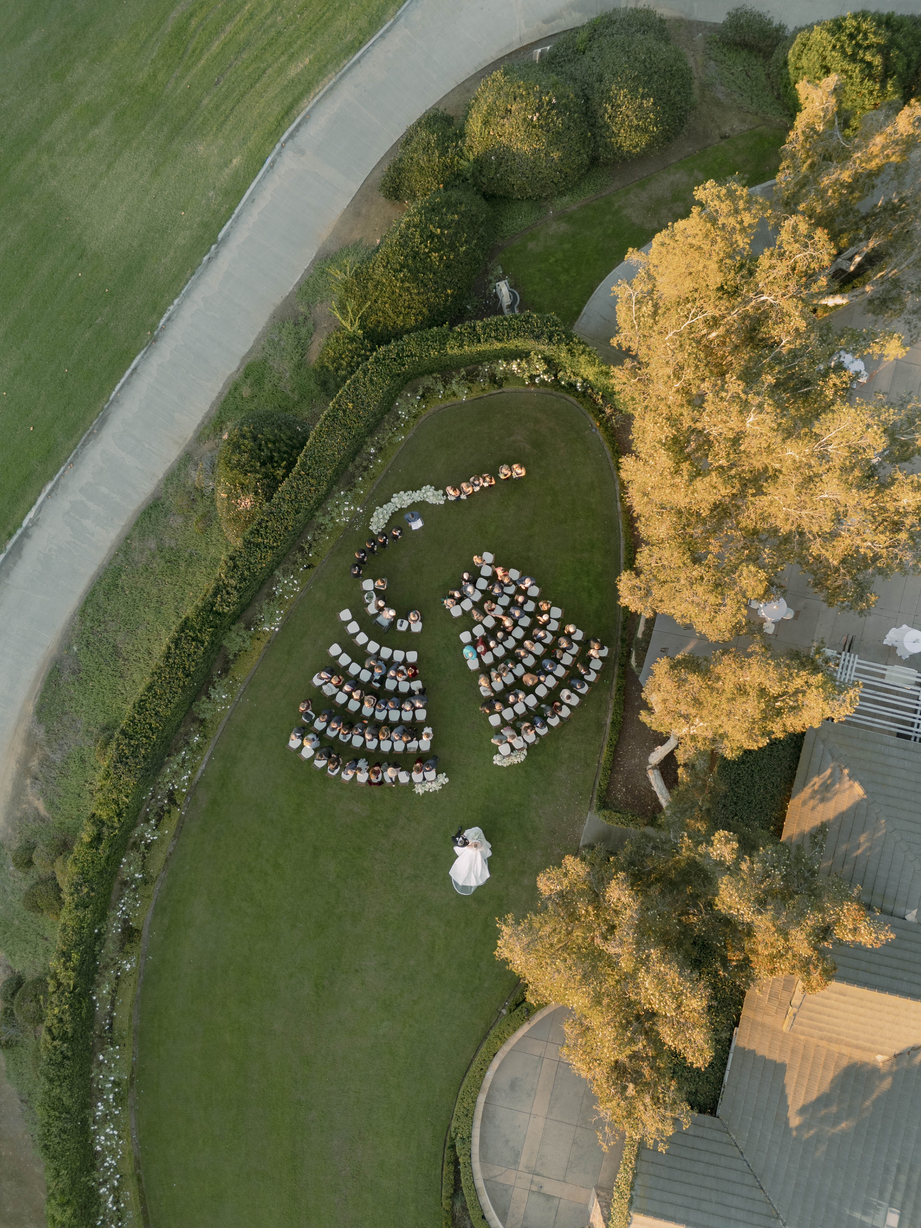 a group of people standing in a circle in a garden