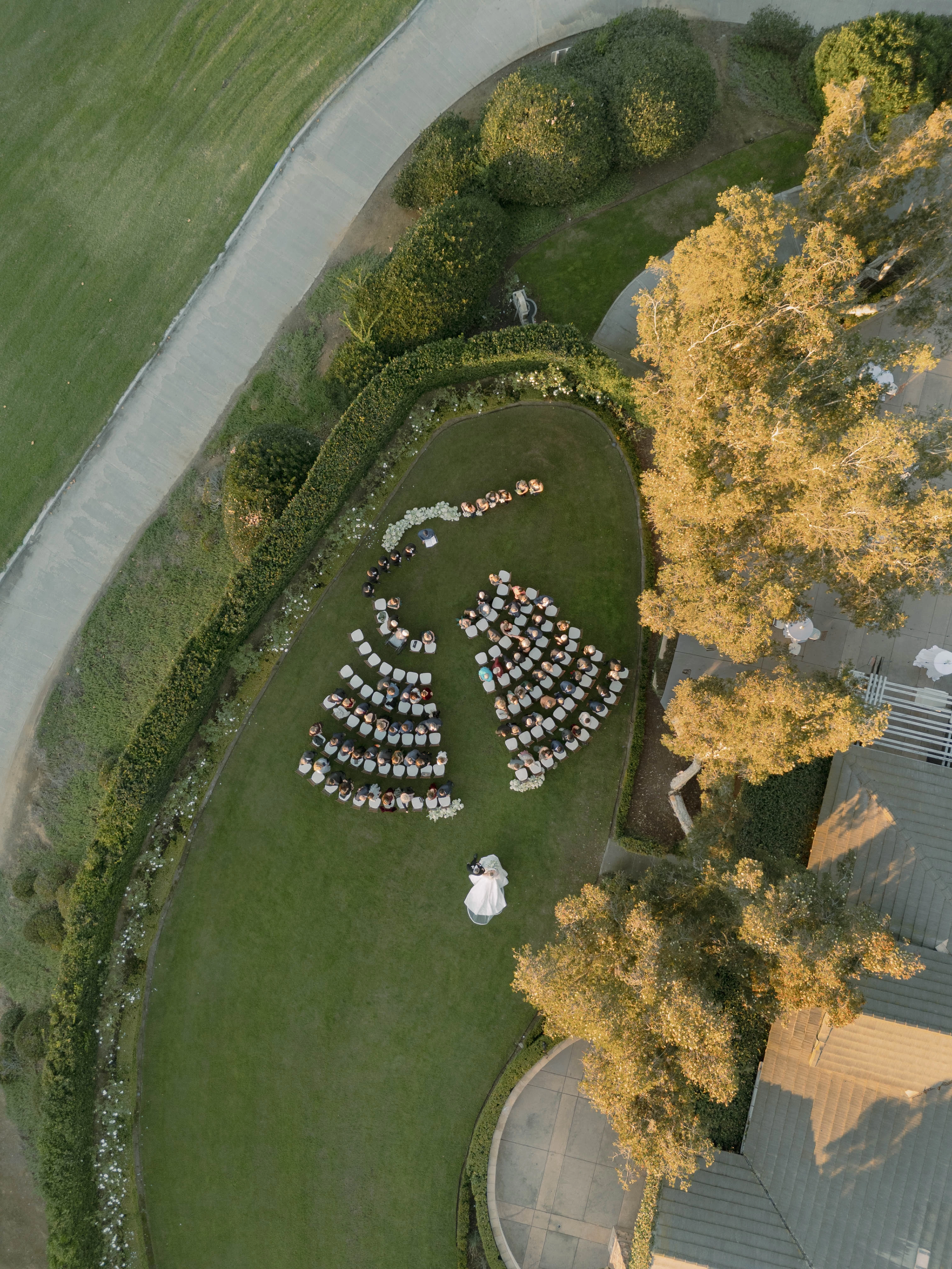 a group of people standing in a circle in a garden