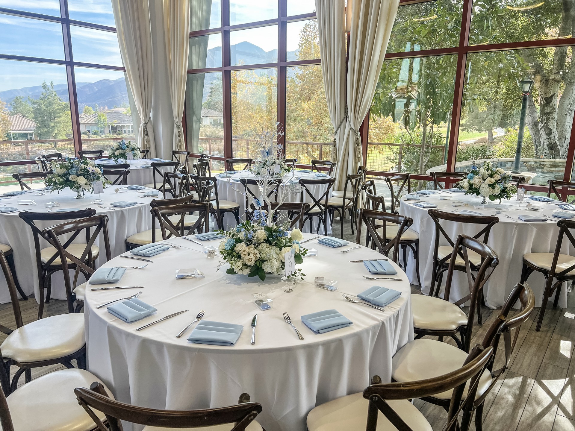 a round white table with white cloths and white napkins