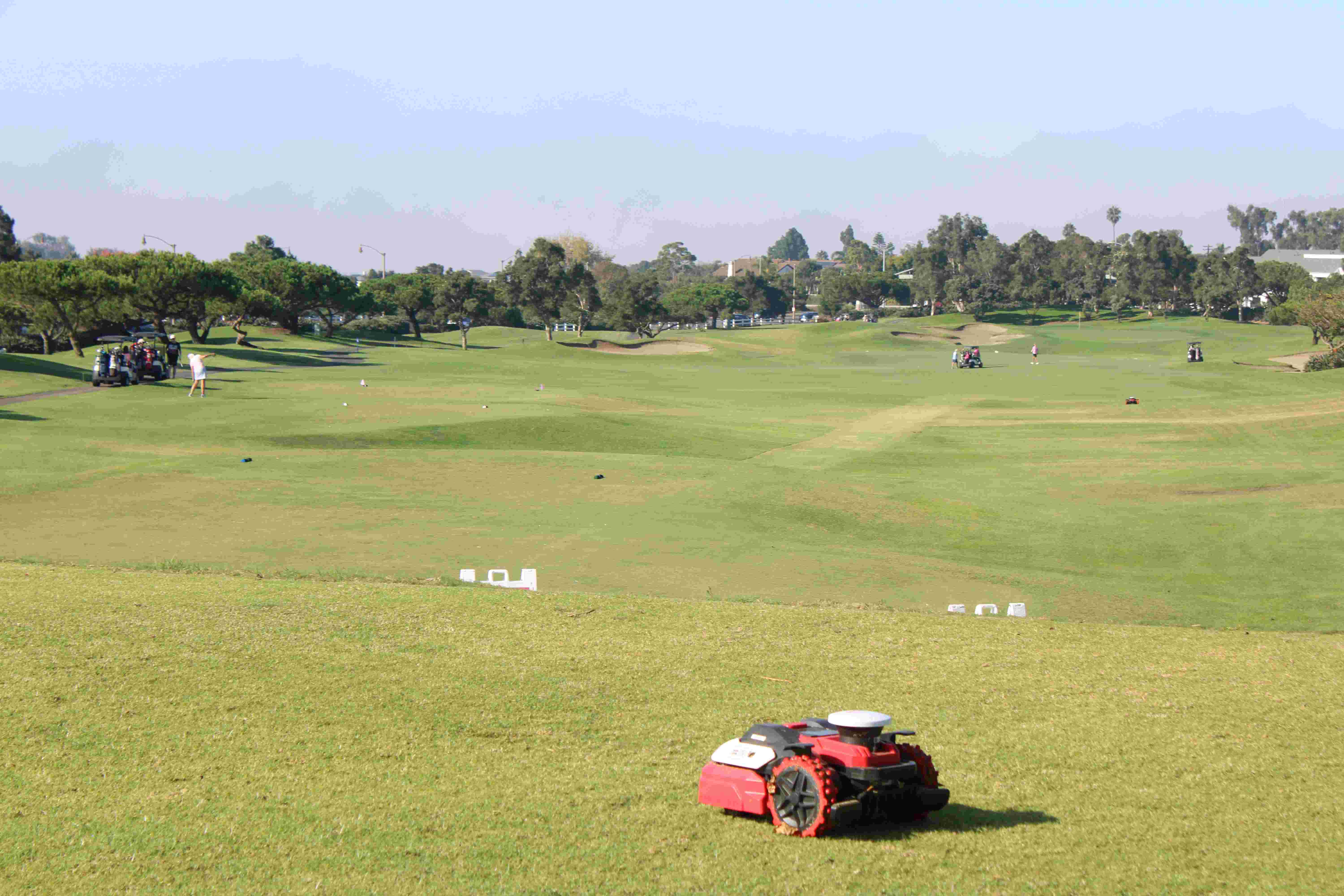 a lawn mower on a golf course