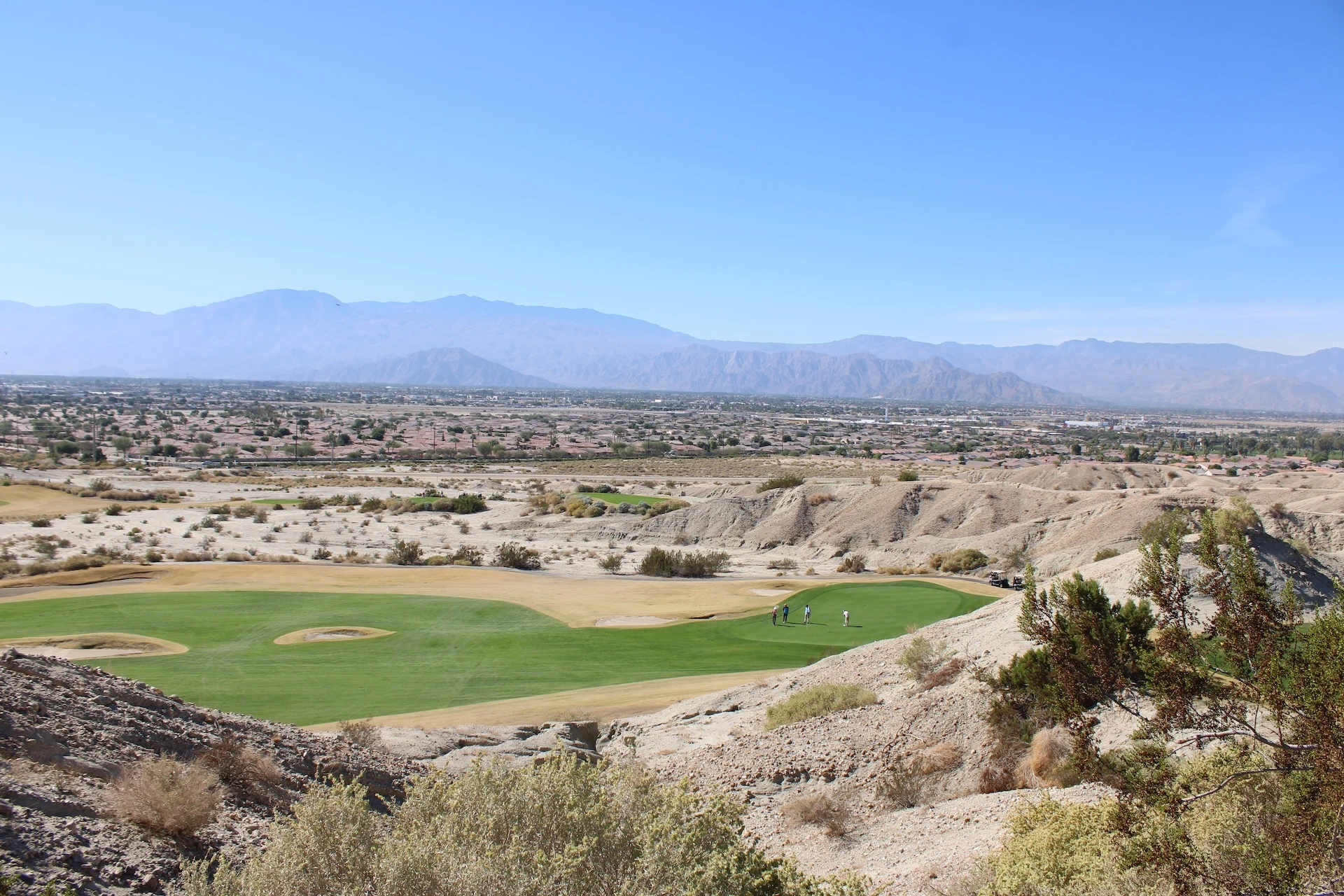a golf course with a landscape in the background