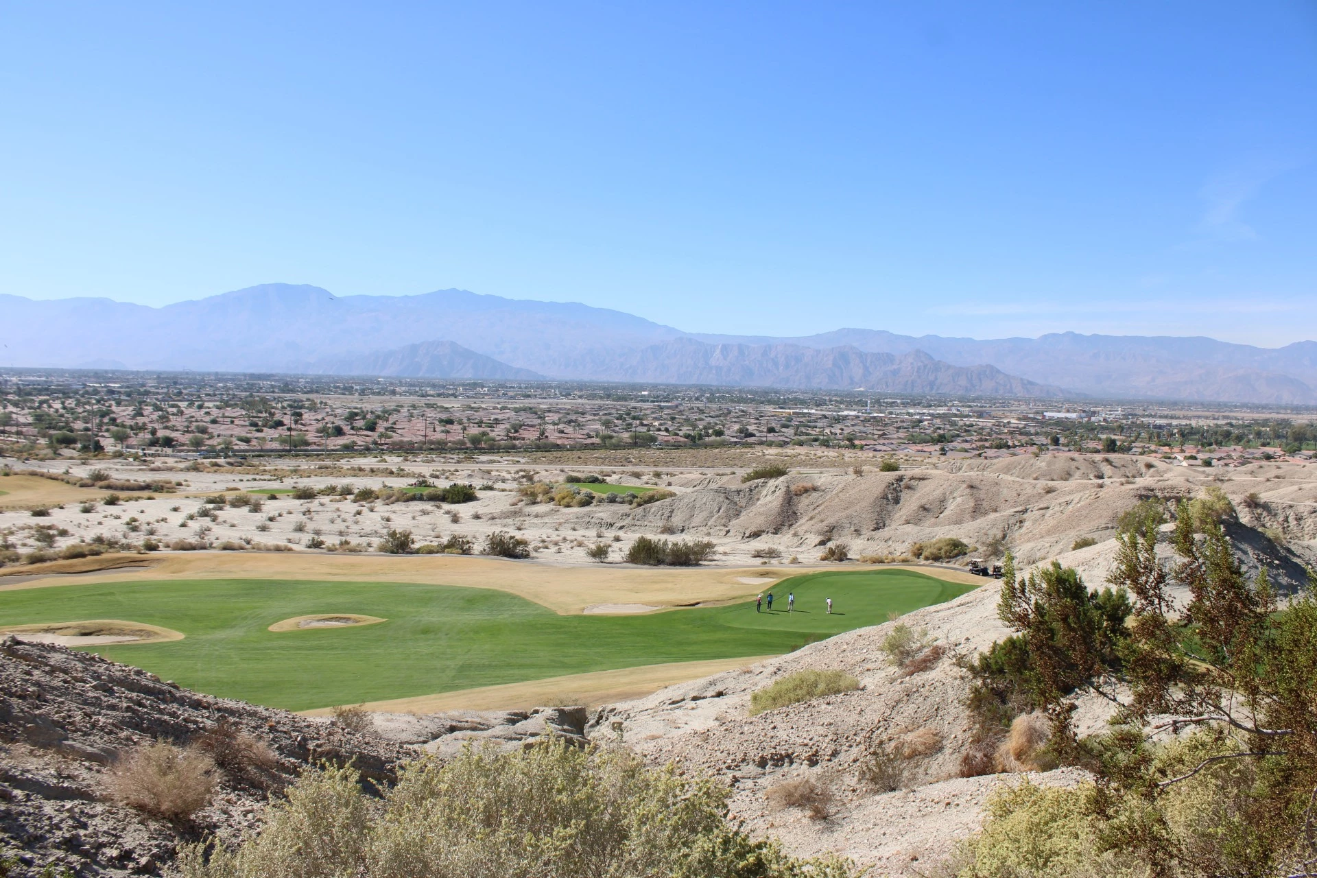 a golf course with a landscape in the background