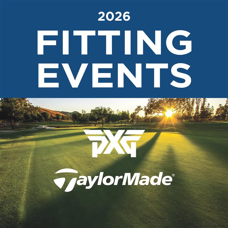 a golf course with sun shining through the trees