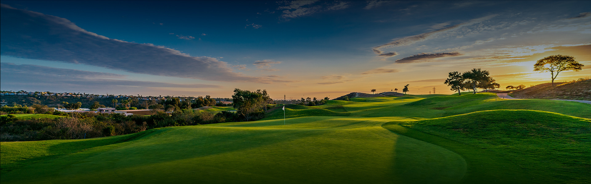 golf course with sun setting in the back