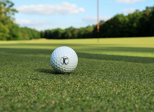 close up of a golf ball with the letters jc on it