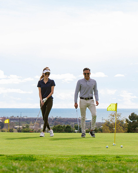 a man and woman wearing sunglasses and playing golf