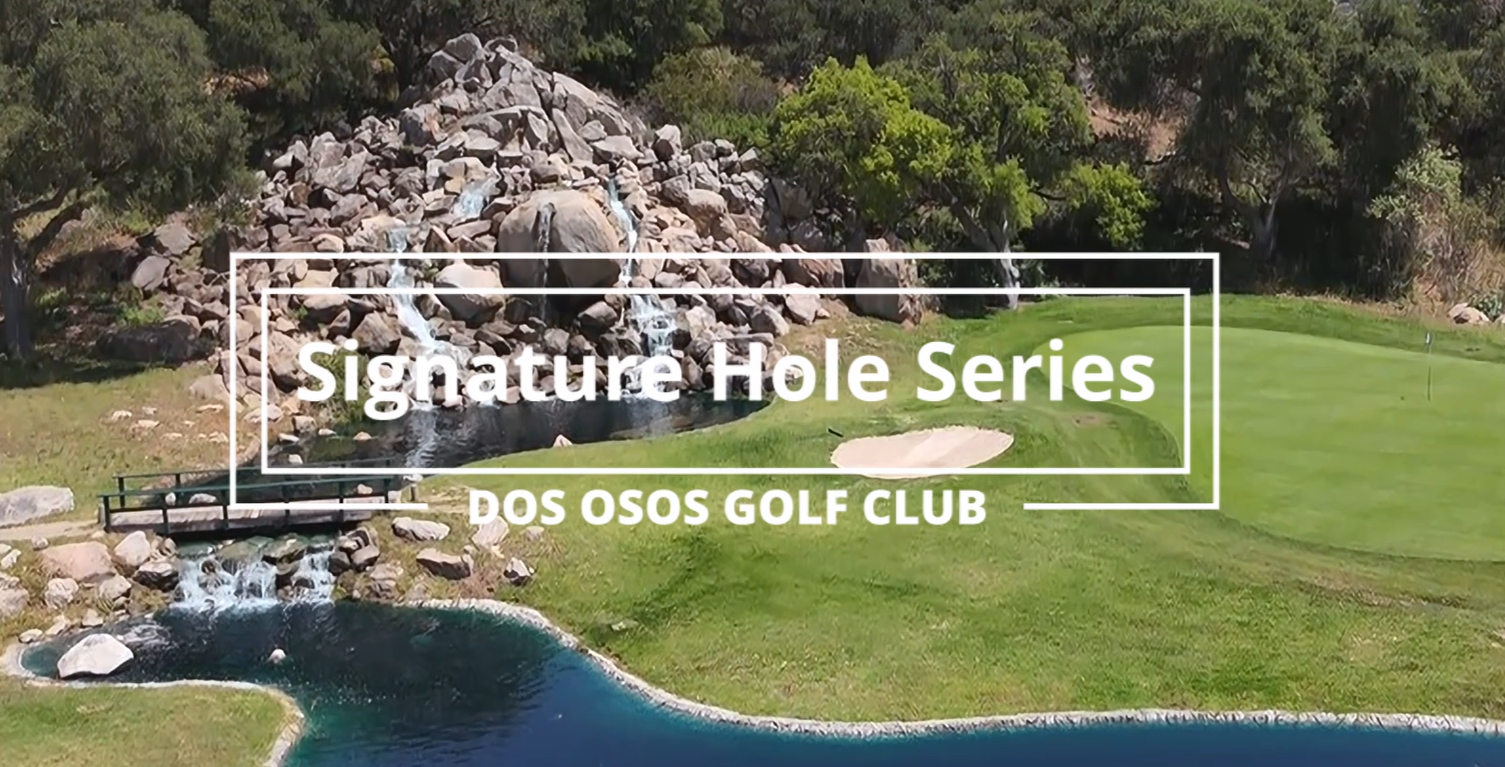 a golf course with a waterfall and rocks