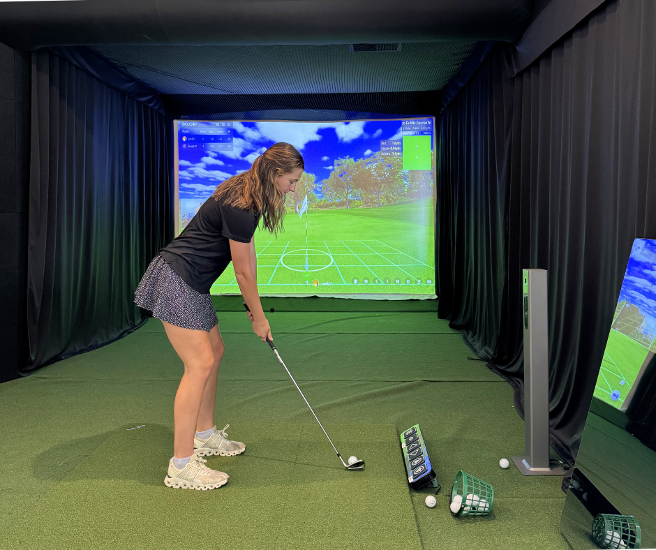 a woman playing golf in a room