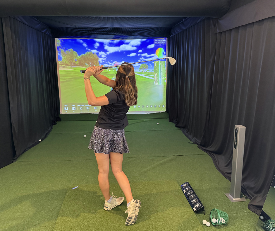 a woman playing golf in a room