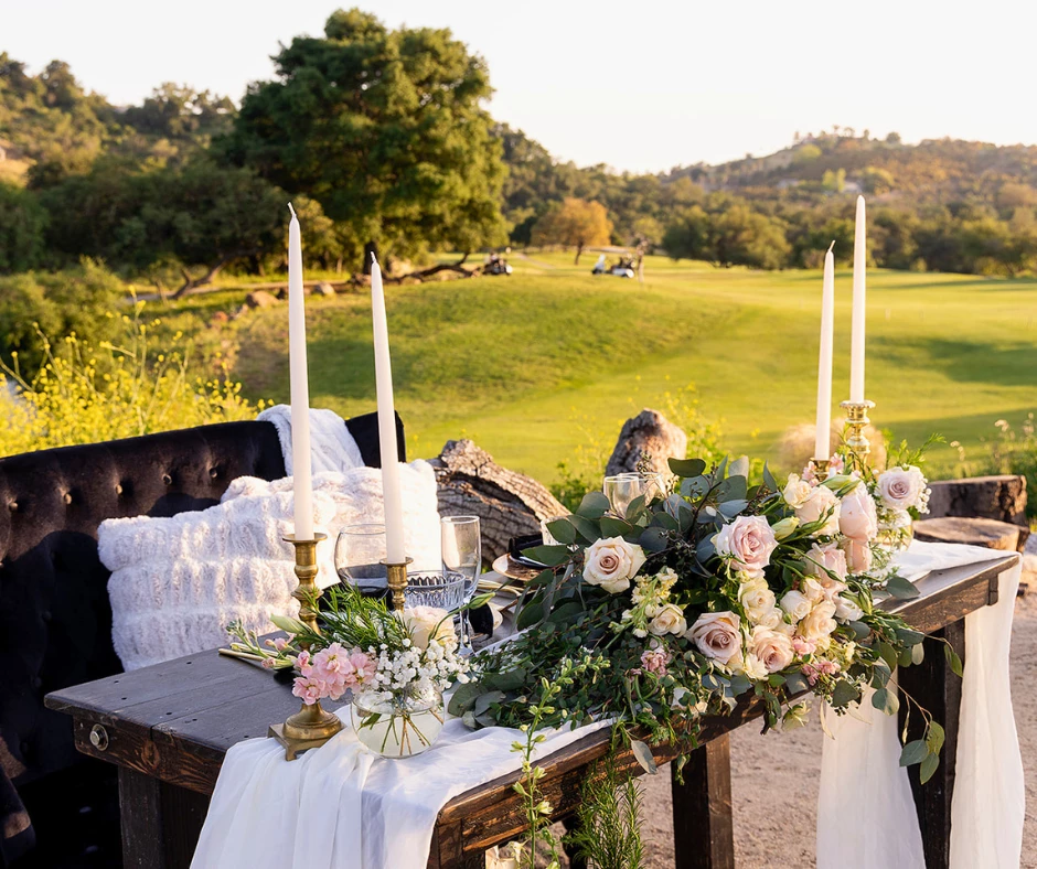 a table with candles and flowers on it