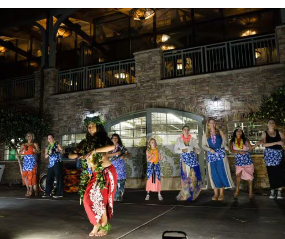 a group of women dancing in front of a building