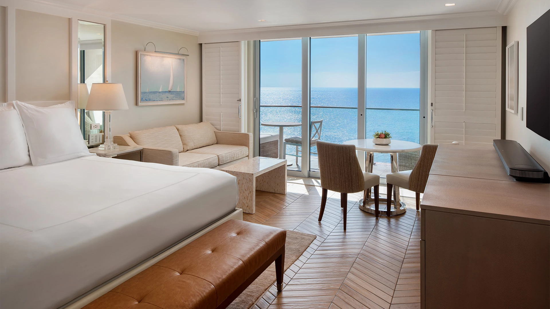 a room with a bed and a table and chairs