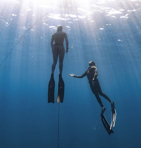 a man and woman in scuba gear