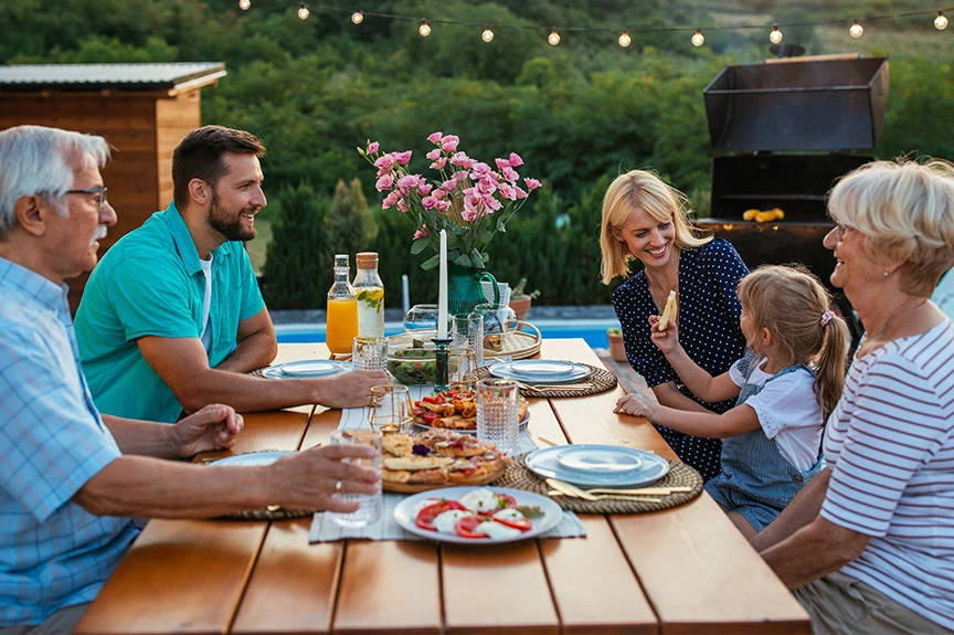 family having lunch at a picnic table