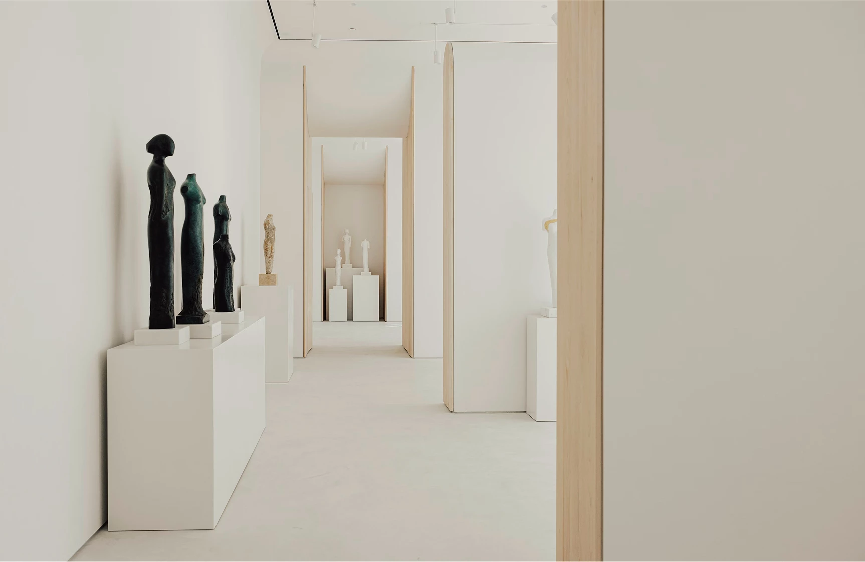 a white room with statues