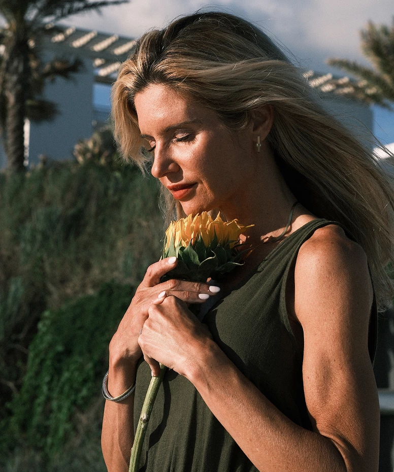 a woman holding a flower