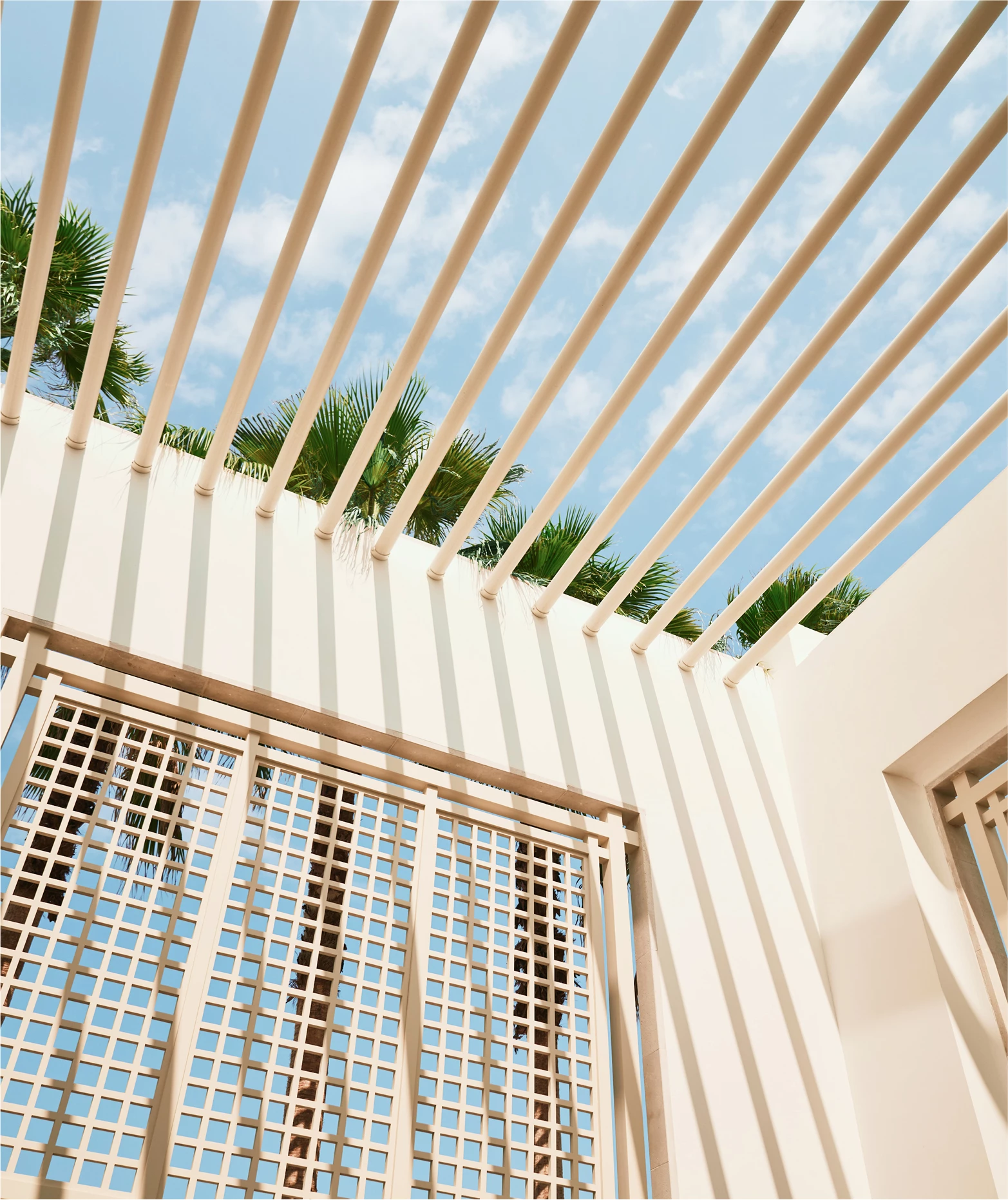a white building with a pergola over it