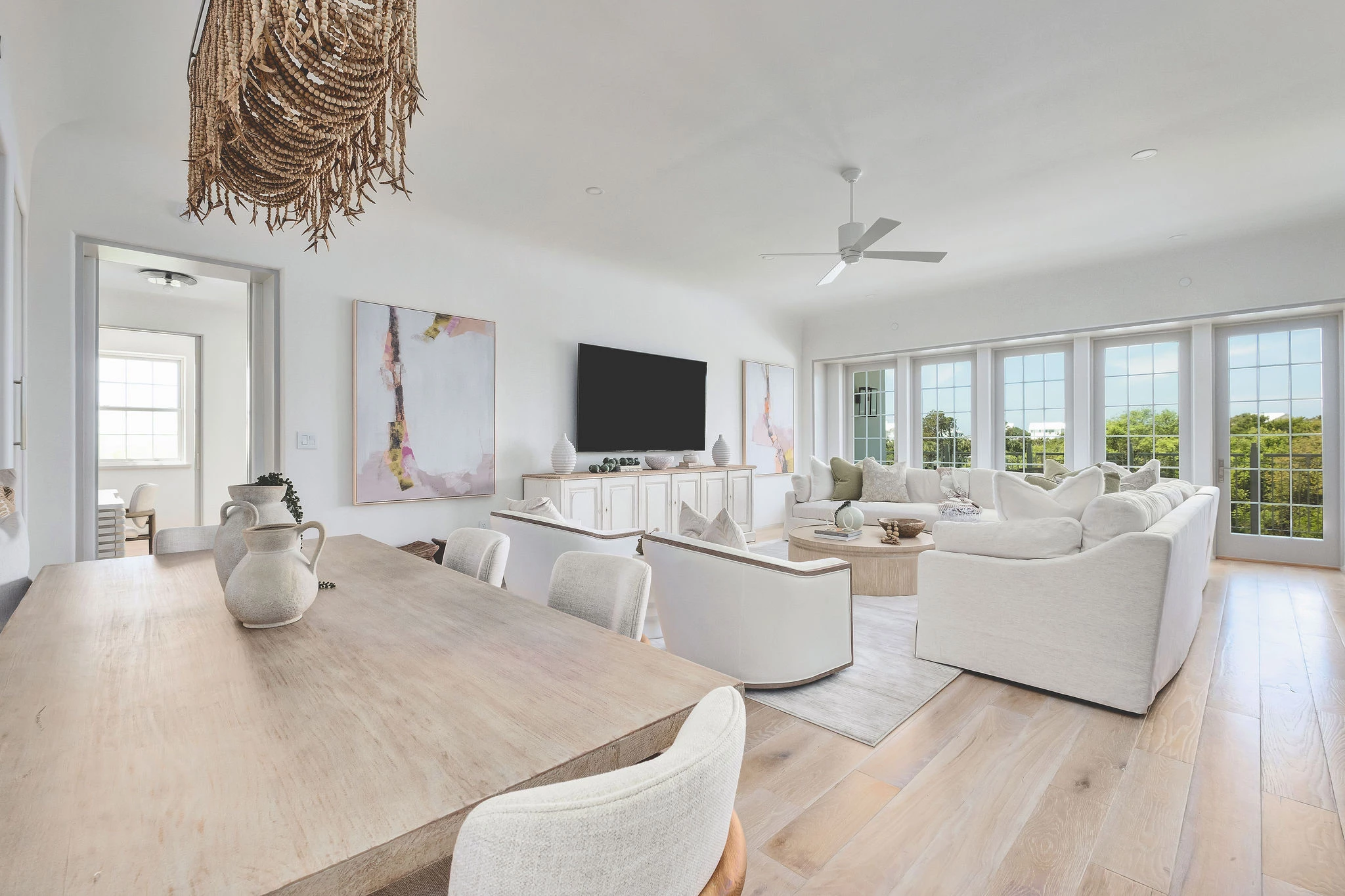 a living room with a large table and chairs
