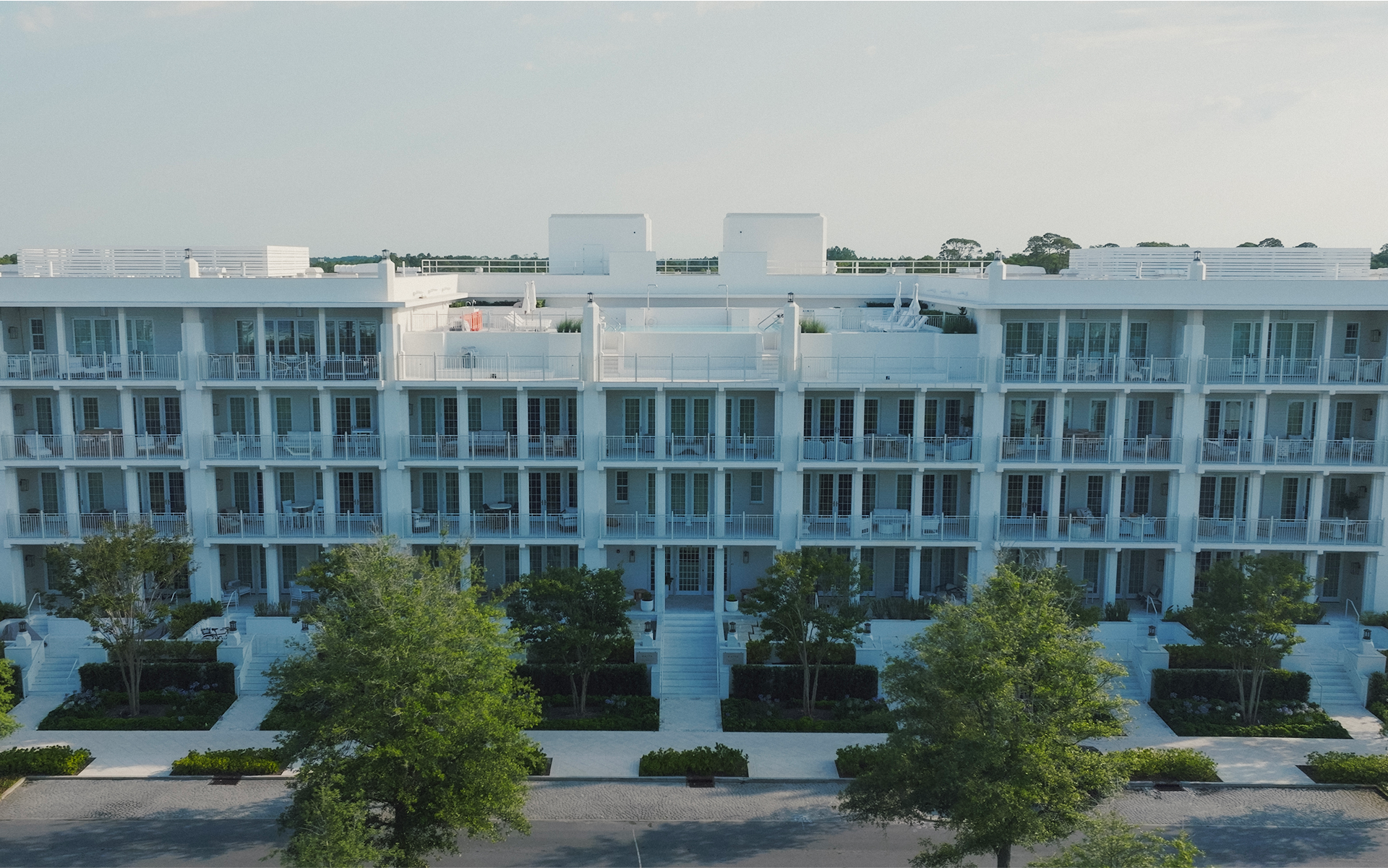 a building with trees and a parking lot