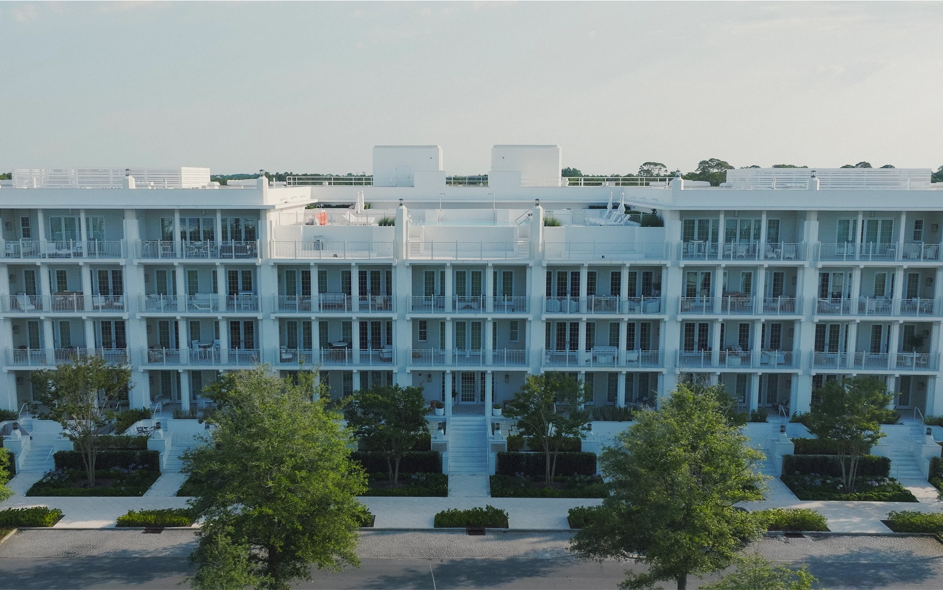 a building with trees and a parking lot