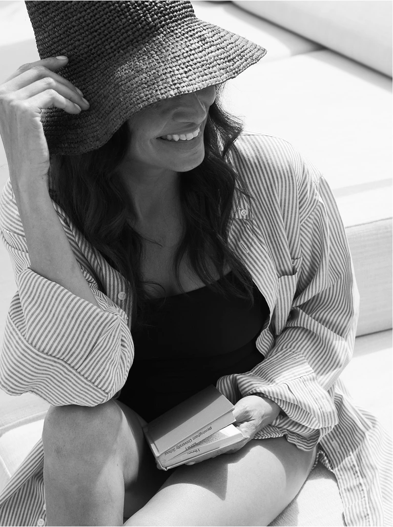 a woman wearing a hat and smiling