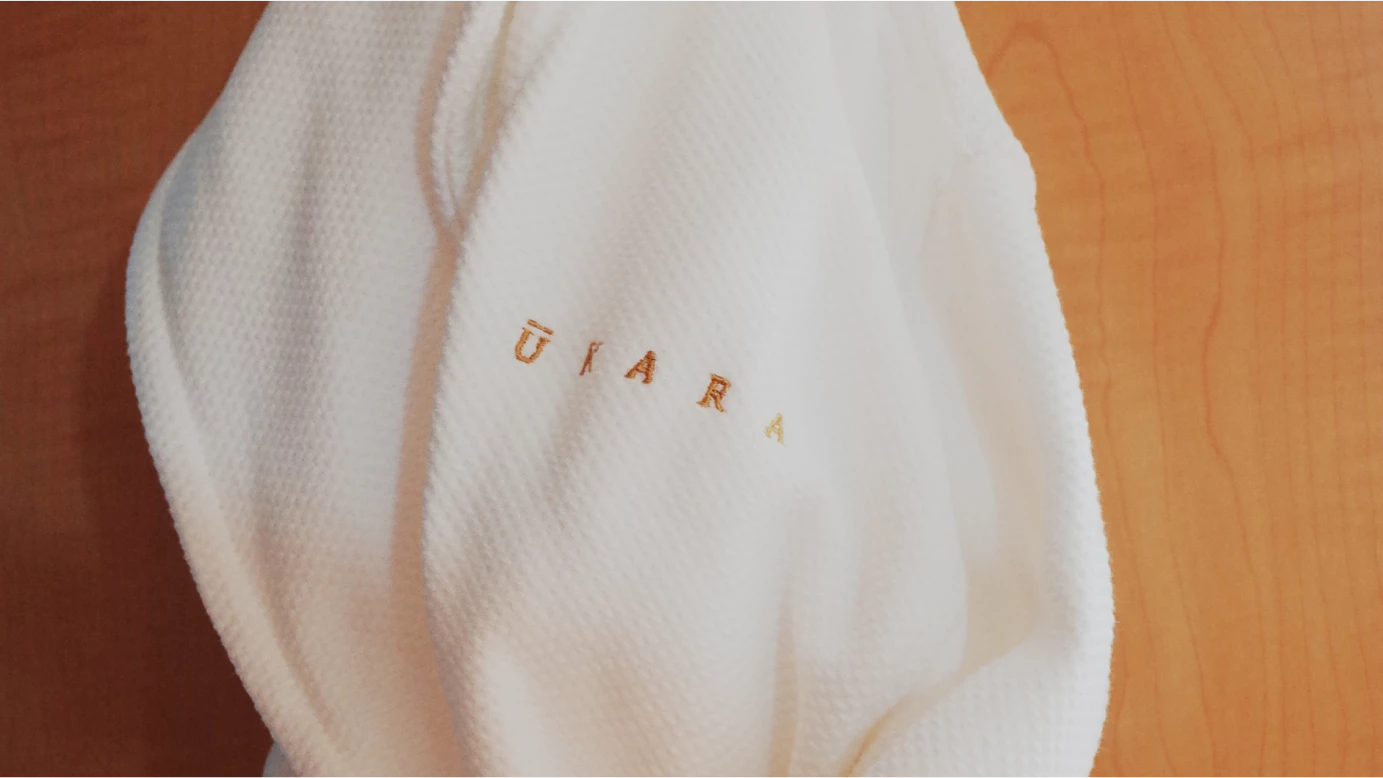 a close up of a white t-shirt with orange ants on it