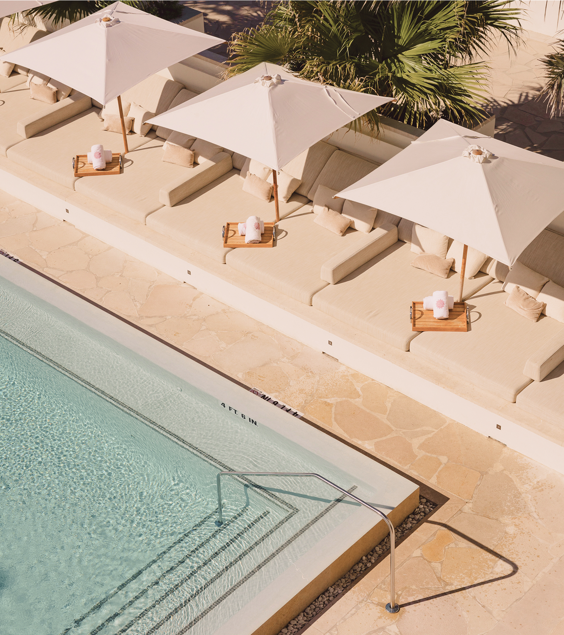 a pool with umbrellas and chairs