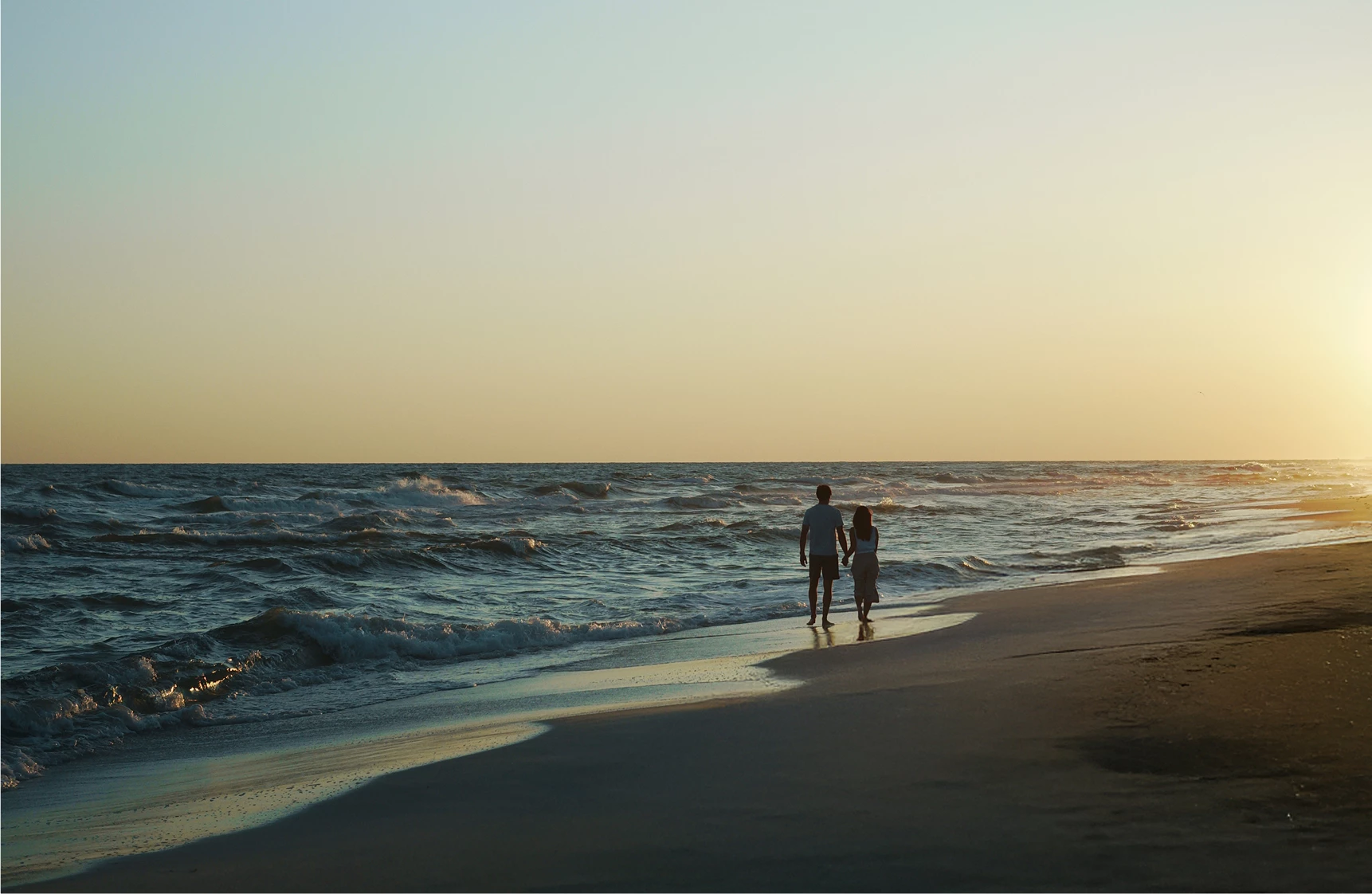 a couple walking on a beach