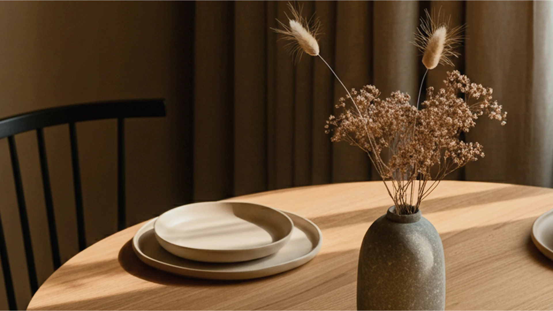 a vase with flowers in it and a plate on a table
