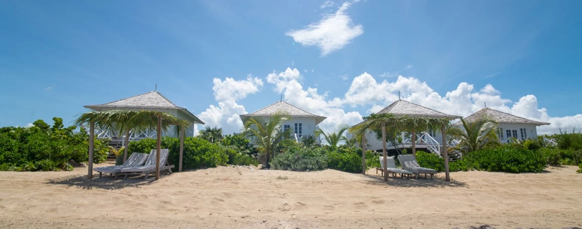 a beach with a few huts