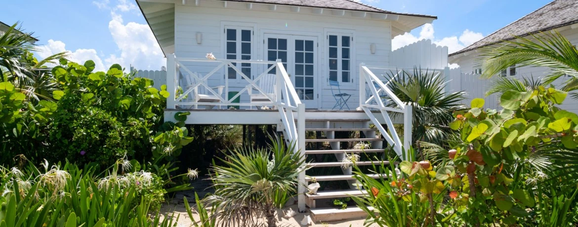 a house with a deck and bushes