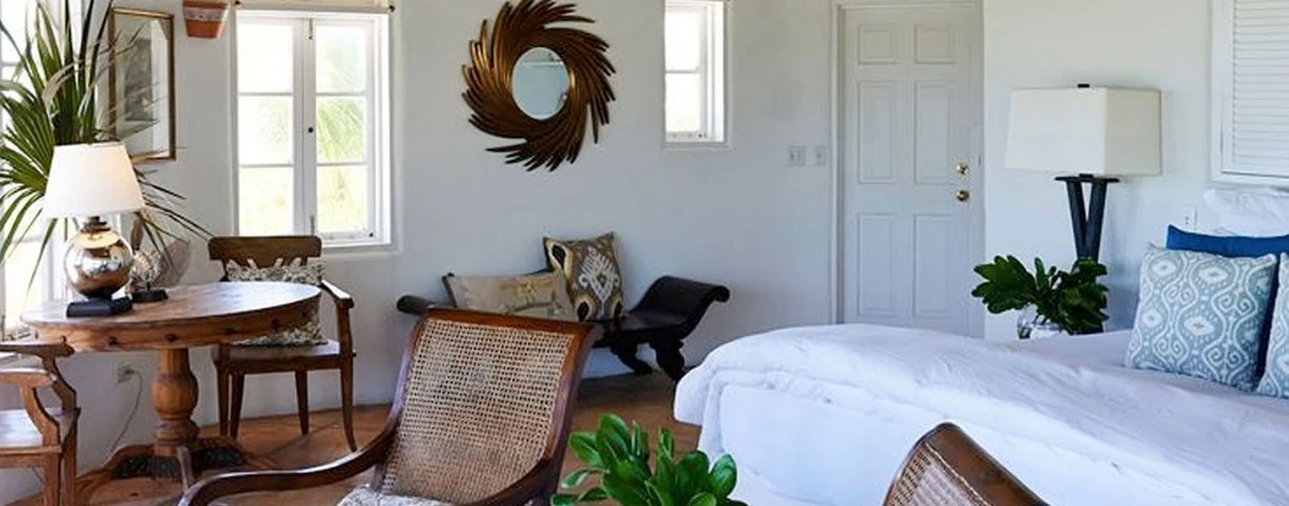 a bedroom with a bed and chairs